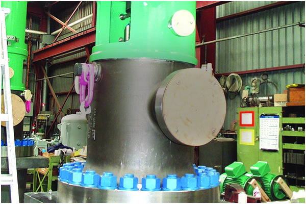 Large industrial valve assembly with blue bolts