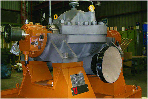 Orange industrial machine on workshop floor