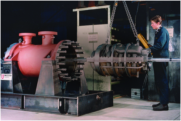 Technician hoisting large industrial pump rotor